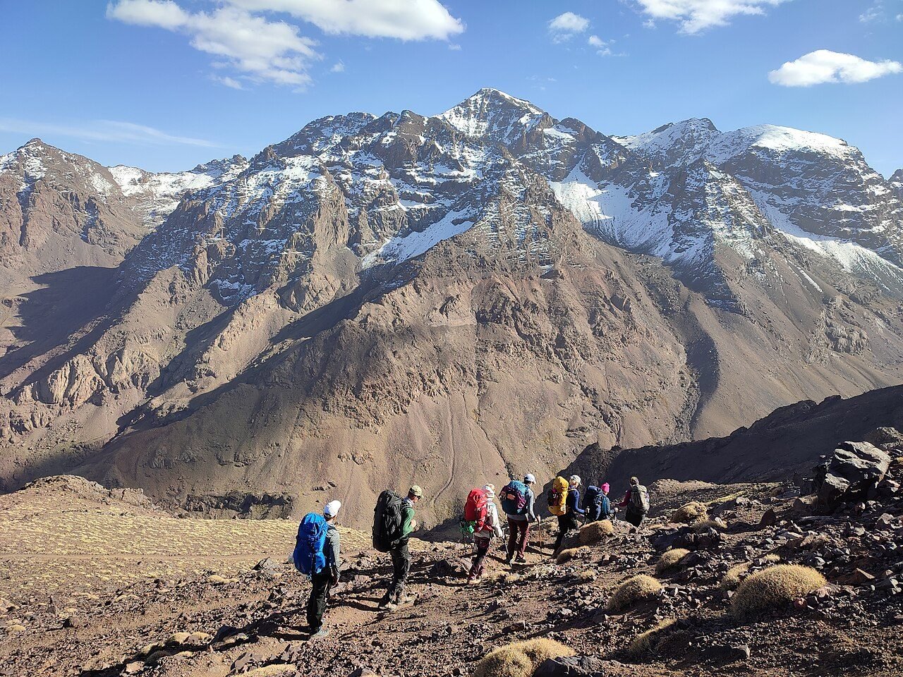 Hikers on the rocky ridge near the summit of Mount Toubkal in the High Atlas, Morocco