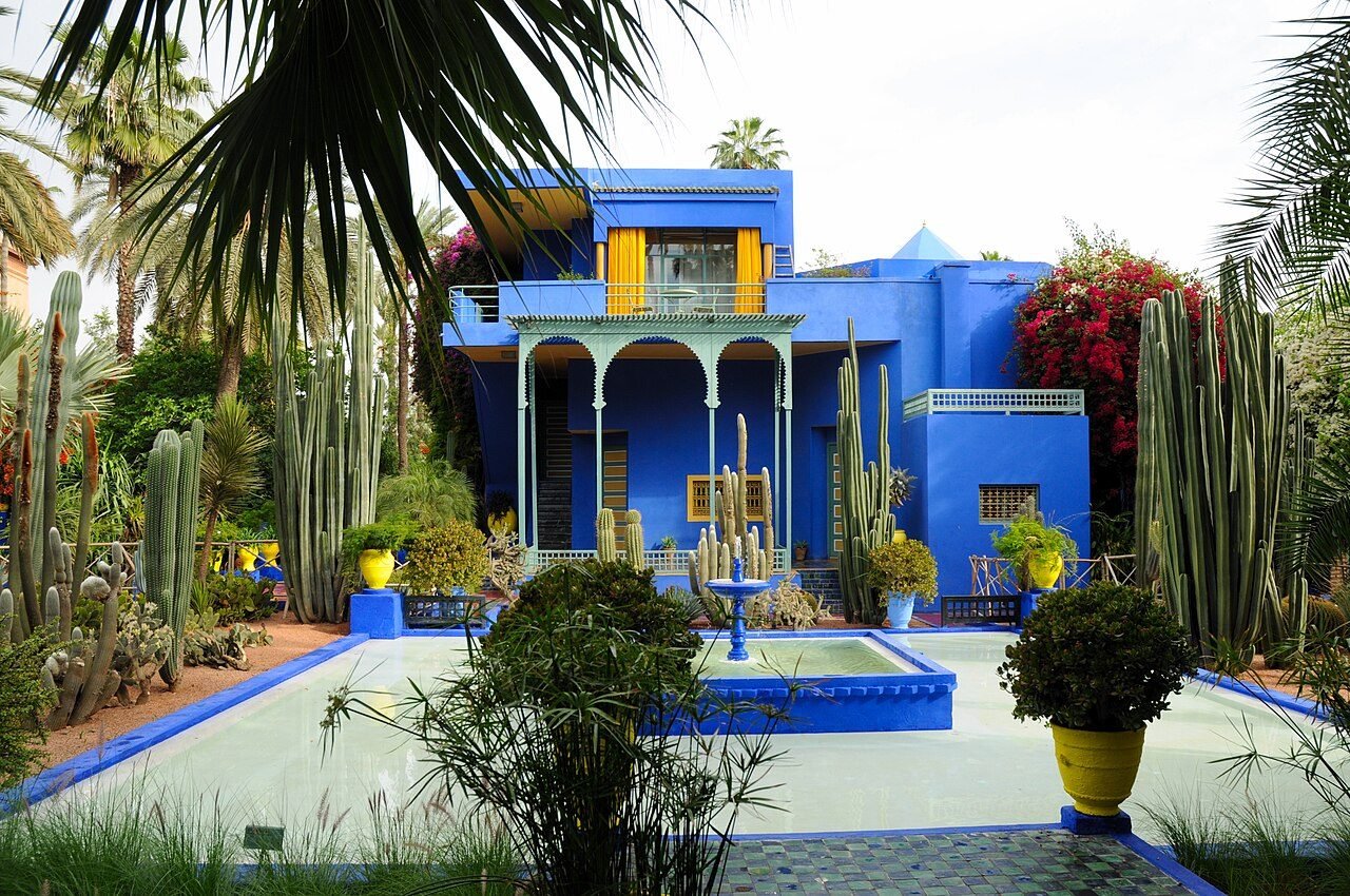 Cobalt-blue Majorelle villa with yellow pots and cactus plants in the Majorelle Garden, Marrakech