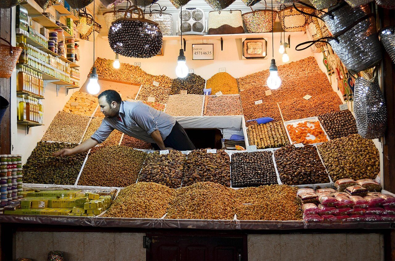 Colourful metal lanterns and leather goods hanging in a covered lane of the Marrakech souks