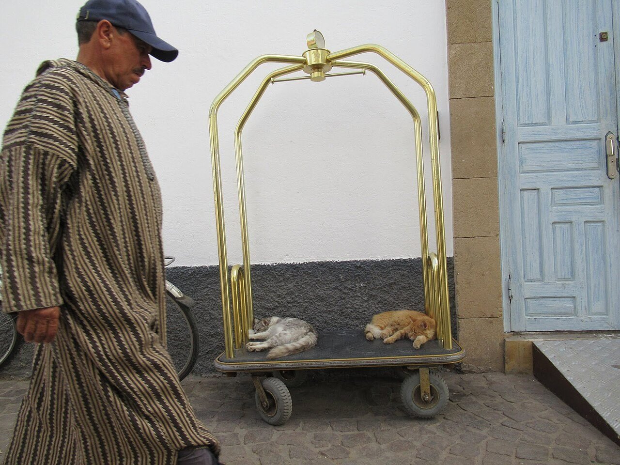 Traveller in a long linen dress and scarf walking through a Marrakech souk