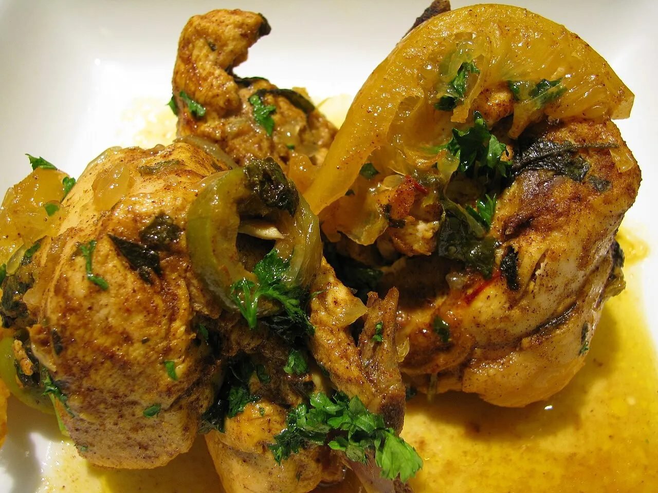 Chicken tagine with preserved lemon and green olives in a clay pot