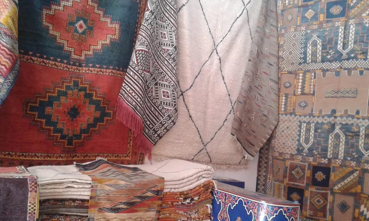 Stacks of colourful Moroccan rugs in a carpet shop in the souk