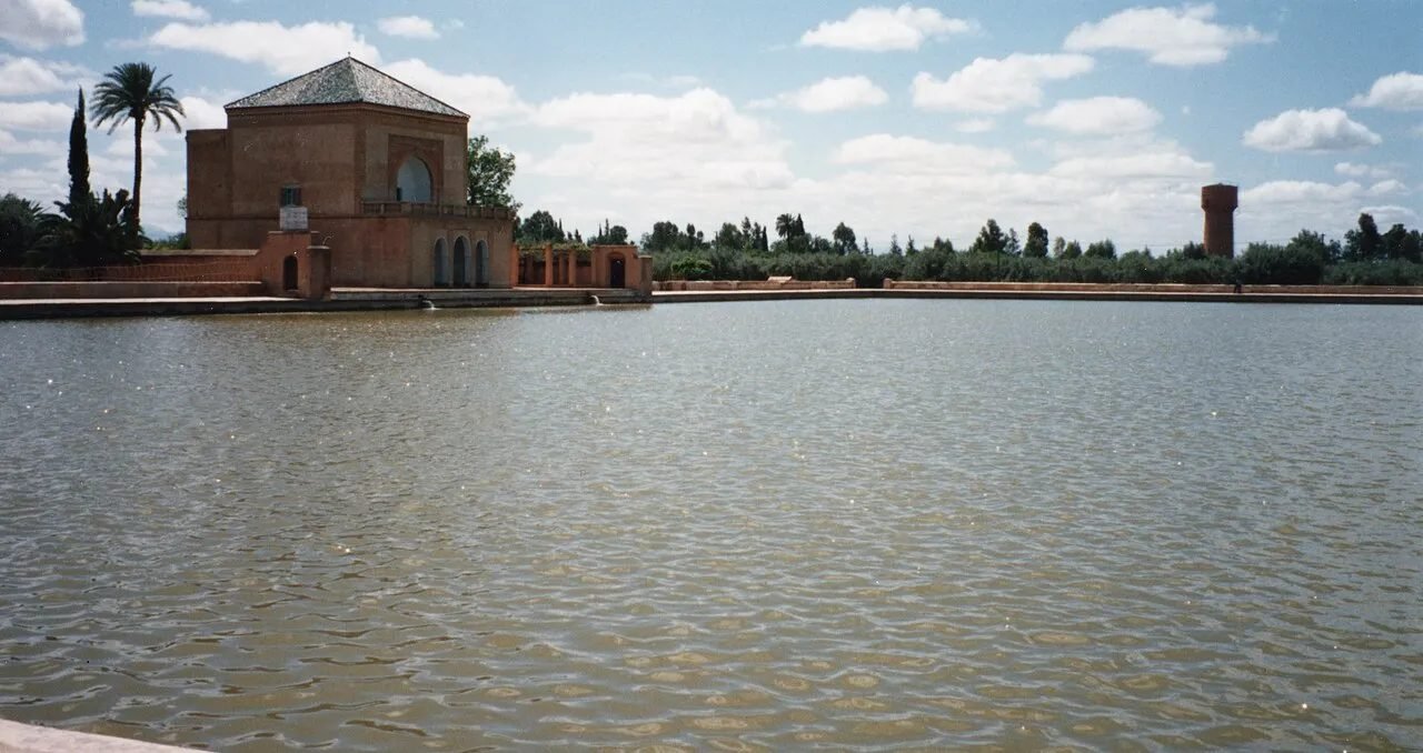 Menara pavilion reflected in its basin with the snowy Atlas Mountains behind