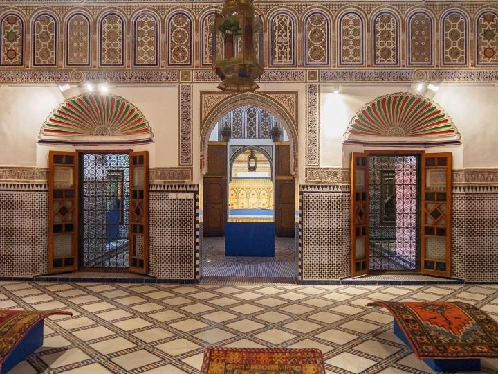 Painted wooden ceiling and courtyard inside the Dar Si Said museum in Marrakech